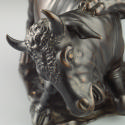 Alternate view of a bronze sculpture of a leopard attacking a bull.  The leopard is actively cl…