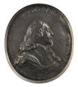 Silver portrait medal of King Charles I in armor (with a soft collar showing at the neck), wear…