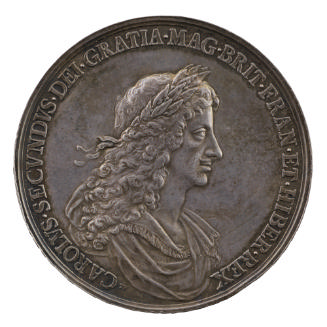 Silver medal of a man wearing drapery and a laurel wreath