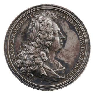 Silver portrait medal of King George I his hair long and curly, wearing a laurel wreath and dra…