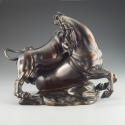 Alternate view of a bronze sculpture of a lion attacking a horse.  The lion is actively clawing…