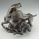 Alternate view of a bronze sculpture of a lion attacking a horse.  The lion is actively clawing…