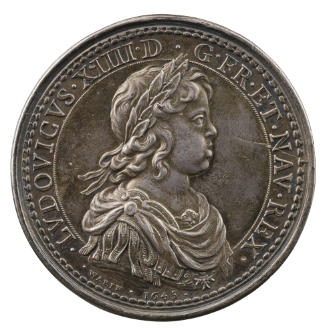 Silver portrait medal of Louis XIV, laureate and with wavy hair, wearing classical armor all’an…