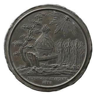 Lead medal depicting a beehive on a bench beneath a tree and before a field of wheat; little bi…