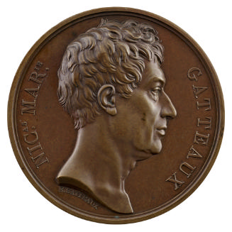 Bronze medal of a man in profile to the right