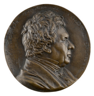 Bronze medal of a man in profile to the right wearing a plain collar, cravat, and overcoat