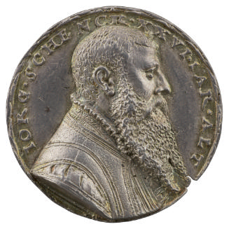 Silver medal of a man with short hair and a long beard, wearing a cloak with ruff collar
