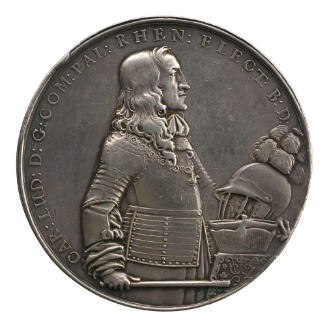 Silver medal of a standing man facing the right and wearing armor, cravat, and Order of the Gol…