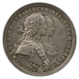 Silver medal of a man and woman in profile to the right