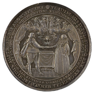 Silver medal depicting a man and woman clasping hands while the dove of the Holy Ghost descends…