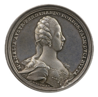Silver medal of a woman in profile to the right wearing earrings, pearls in her hair, and a jew…