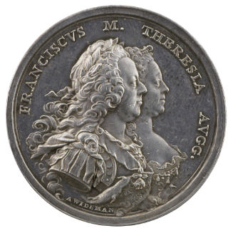 Silver medal of a man and woman in profile to the right