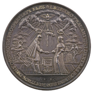 Silver medal depicting a man and woman pledging their troth in front of an altar
