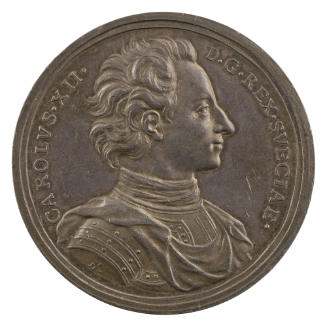 Silver medal of a man wearing a harness with a draped mantle