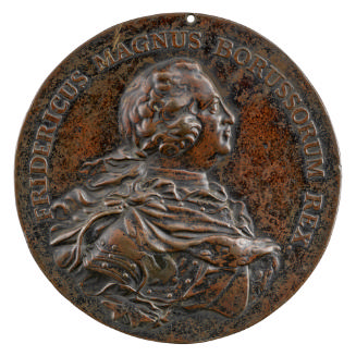 Bronze medal of a man wearing a harness with a draped mantle