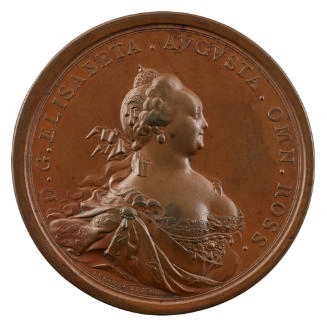 Bronze medal of a woman with an imperial crown on her head and hair tied with a ribbon around h…