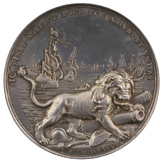 Silver medal depicting, in the foreground, lion standing upon implements of war, two cannons, a…