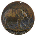 Bronze medal of an elephant walking to the right