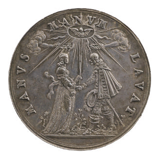 Silver medal depicting a man and woman holding hands beneath a radiant dove, while two hands em…
