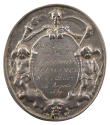 Silver medal of a skeleton, crowned with laurels, holding a scythe in one hand and a flaming to…