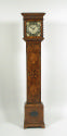 Front view of longcase clock showing marqueted vegetal motifs