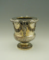 Gold and silver wine cooler with plant designs and rams' heads, side view