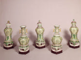 Five piece set of porcelain jars with green blue, and yellow pattern decoration