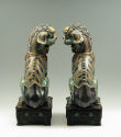 Pair of green porcelain lions, viewed from behind