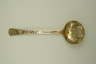 Gilt silver ladle with intricately designed handle and bowl