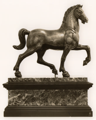 Bronze sculpture of a trotting horse.