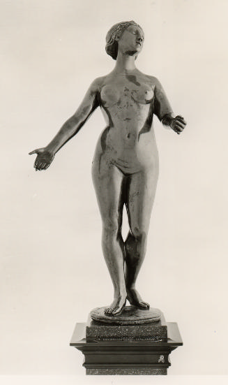 A bronze sculpture of nude Venus.  Her arms are outstretched in front of her and her head is tu…