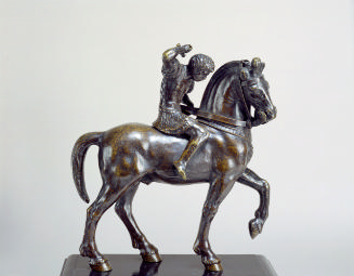 Bronze sculpture of a warrior on horseback.  The warrior figure has his right arm held up as if…