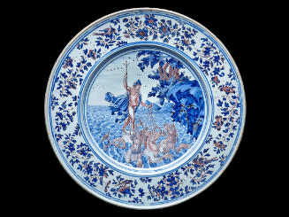 Large circular plate with a mythological scene and ornate border in blue and white