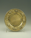 Gilt silver plate with plant and floral design at rim, front view