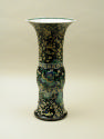 Porcelain vase in bronze form with black ground and floral and vegetal designs
