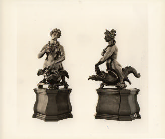 A view of the pair of bronze sculptures, each depicting a harpy bestriding a grotesque fish.
