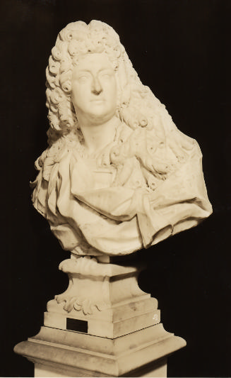 Marble sculpture, possibly depicting Louis XIV.  His head is turned to his left, he has on a la…