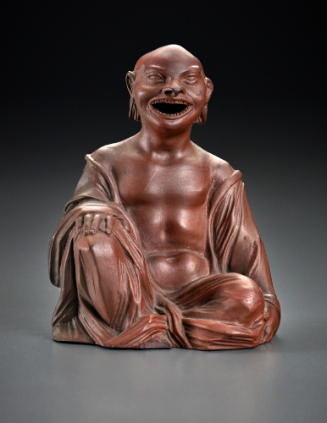 brown incense burner in the shape of a seated Buddhist divinity