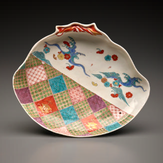 shell-shaped dish with patterns and a landscape