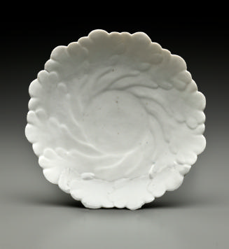 white dish with vegetal relief decoration