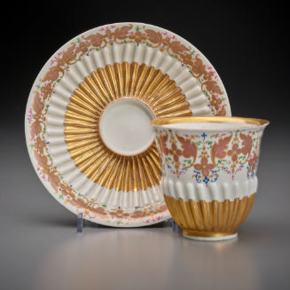 tea cup and saucer with fluted decoration in white and gold