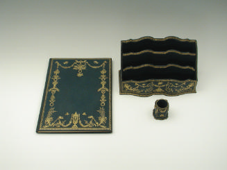 Photograph of three items in blue leather desk set with gold emboss