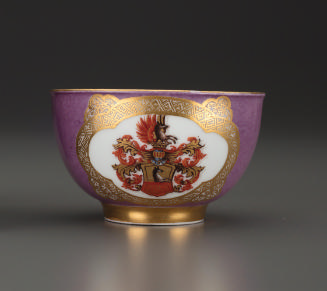 Tea bowl with crest painted at center and gilt decoration