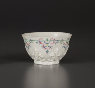 Tea bowl with floral relief and painted decorative motif