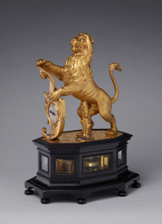 Automaton Lion Clock consisting of a gilt-bronze lion holding up a dial, placed on a ebonized b…