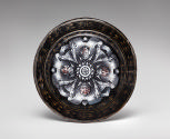 Back view of black painted enamel dish depicting Saturn on a chariot