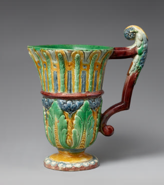 Glazed earthenware ewer with a parrot shaped handle