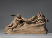 Back of terracotta sculpture of a pietà scene with two mourning pitti.  The figure of Jesus is …
