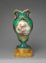 Porcelain vase with ear-like forms and with images of birds in trees on a gilt bronze base