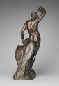 Back view of a bronze sculpture of Ganymede.  His head is pointed down, he looks at an eagle th…